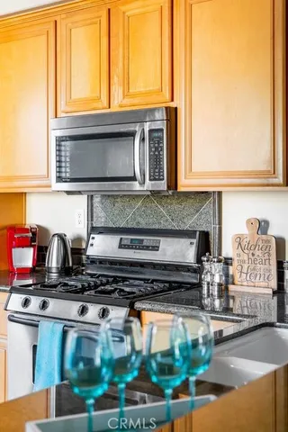 a kitchen with stainless steel appliances granite countertop a stove and a sink
