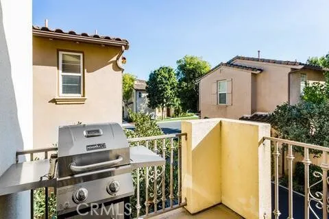a kitchen with a sink and a stove with wooden floor
