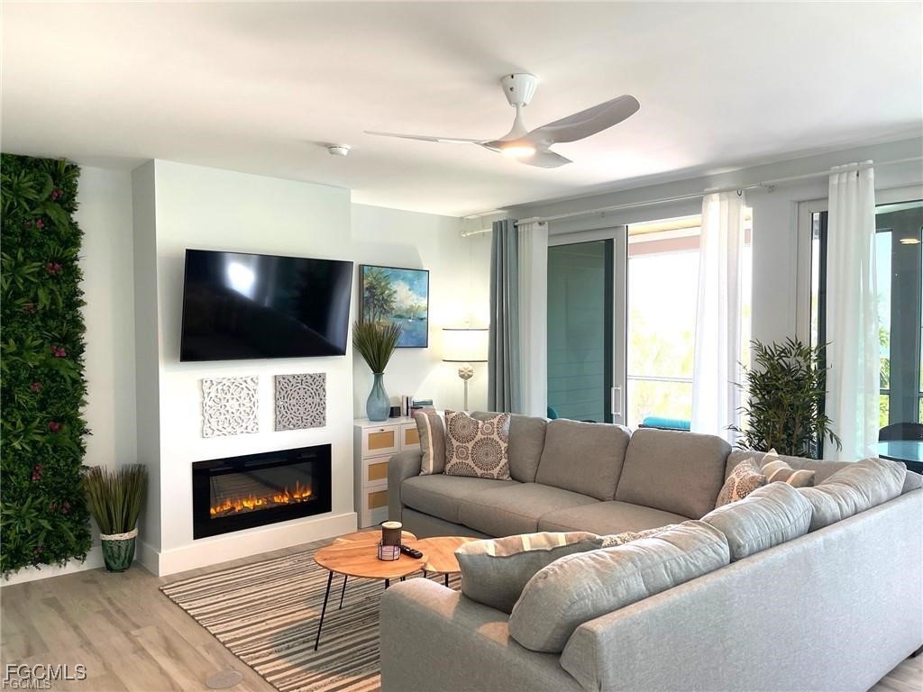 640 Gulf Lane, Unit 3 Captiva, FL 33924 - Photo 21 of 50 a living room with a fireplace a flat screen tv and a fireplace