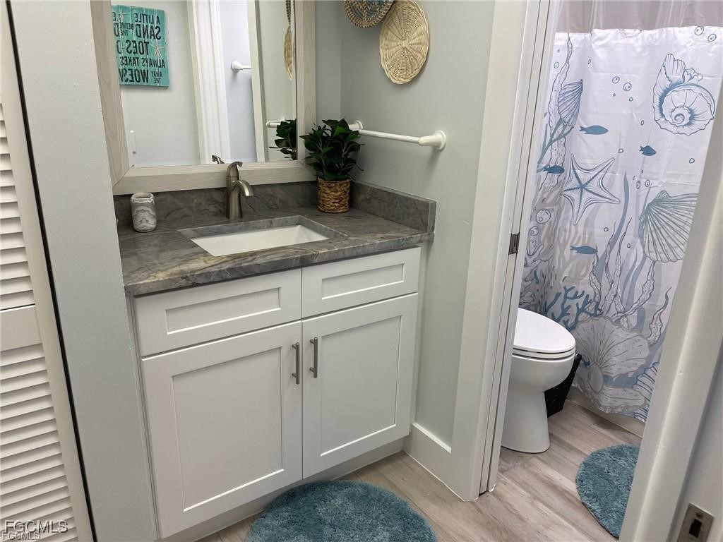 640 Gulf Lane, Unit 3 Captiva, FL 33924 - Photo 36 of 50 a bathroom with a granite countertop sink toilet and a mirror