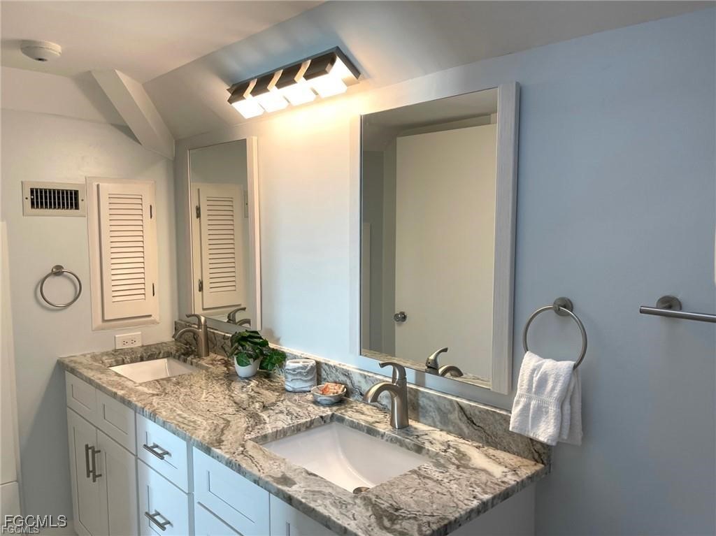 640 Gulf Lane, Unit 3 Captiva, FL 33924 - Photo 41 of 50 a bathroom with a granite countertop sink and a mirror