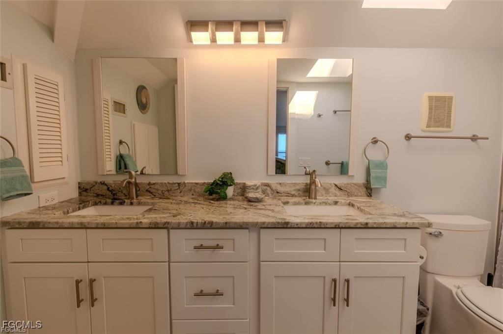 640 Gulf Lane, Unit 3 Captiva, FL 33924 - Photo 44 of 50 a bathroom with a granite countertop sink and a mirror