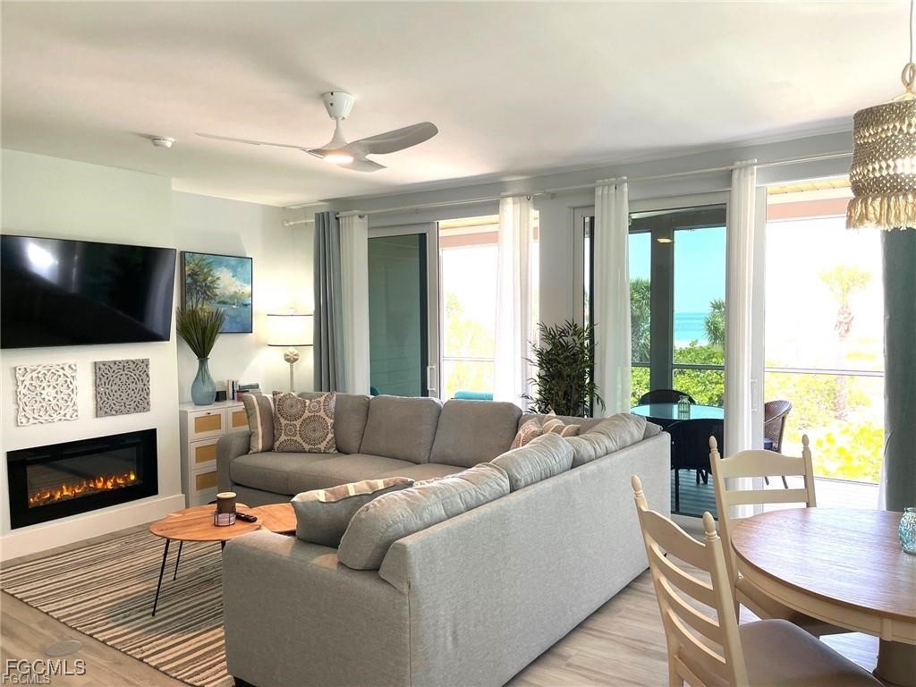 640 Gulf Lane, Unit 3 Captiva, FL 33924 - Photo 9 of 50 a living room with furniture a fireplace and a flat screen tv