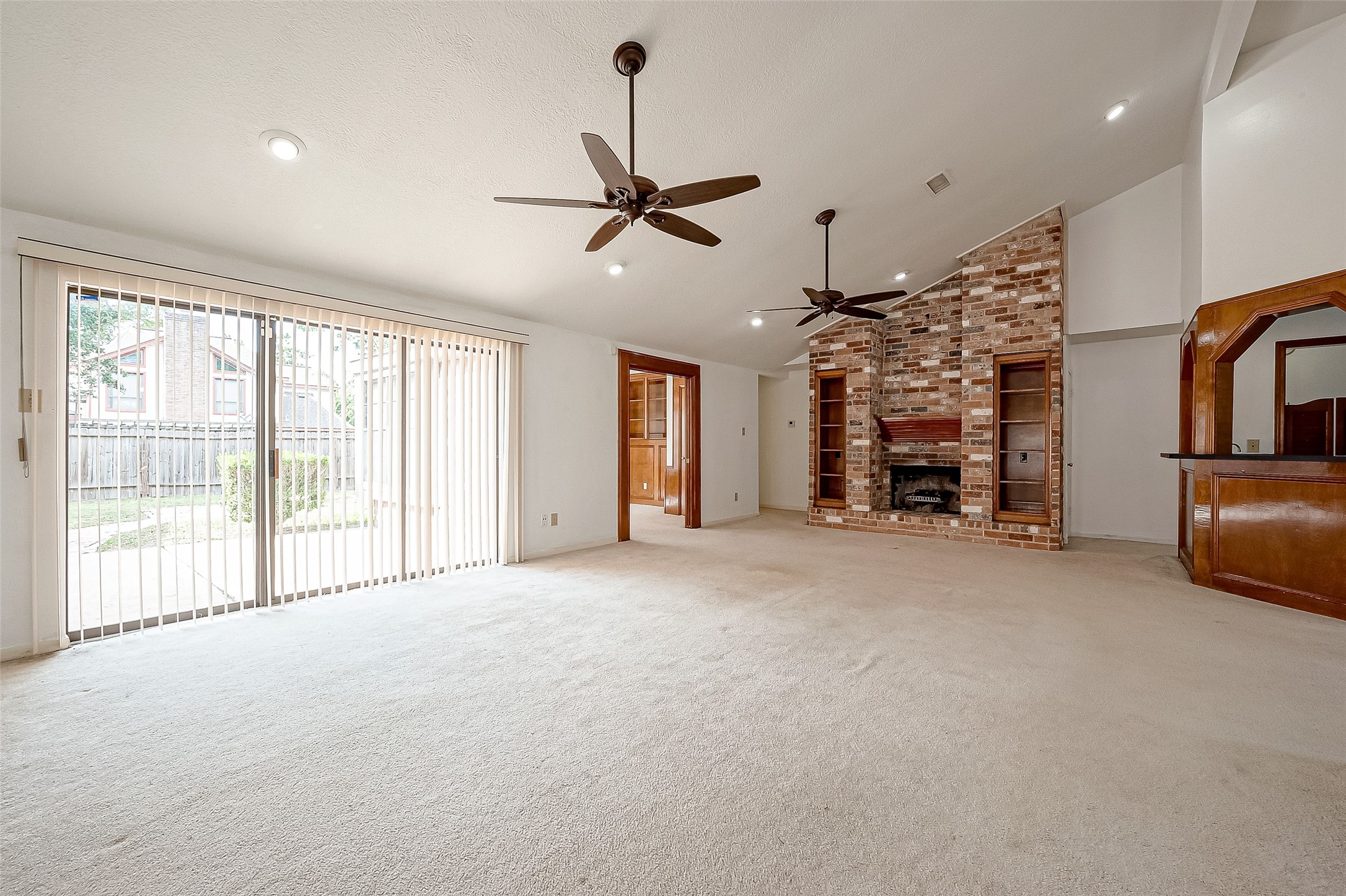 14818 La Rana Drive Houston, TX 77083 - Photo 11 of 50 a view of empty room with fireplace and windows
