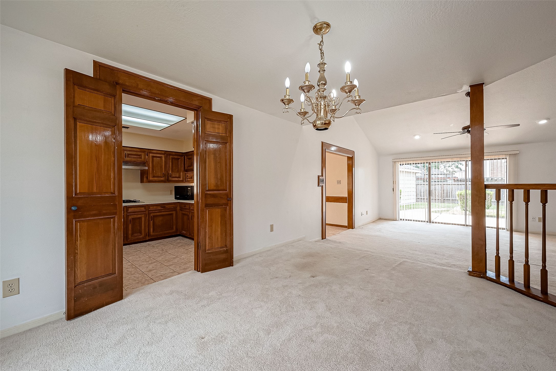 14818 La Rana Drive Houston, TX 77083 - Photo 14 of 50 a view of a hallway with wooden floor and a kitchen