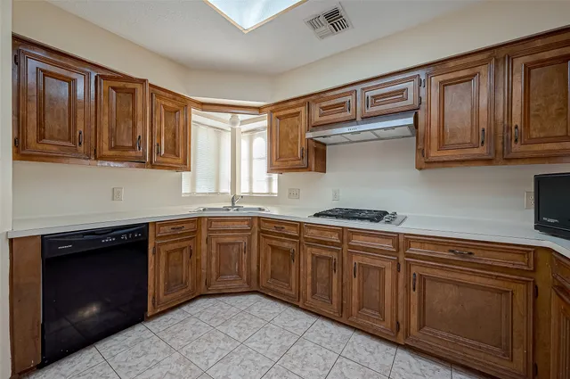 a kitchen with stainless steel appliances granite countertop a stove sink and cabinets