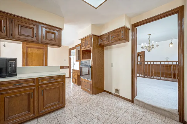 a kitchen with stainless steel appliances granite countertop a refrigerator and cabinets