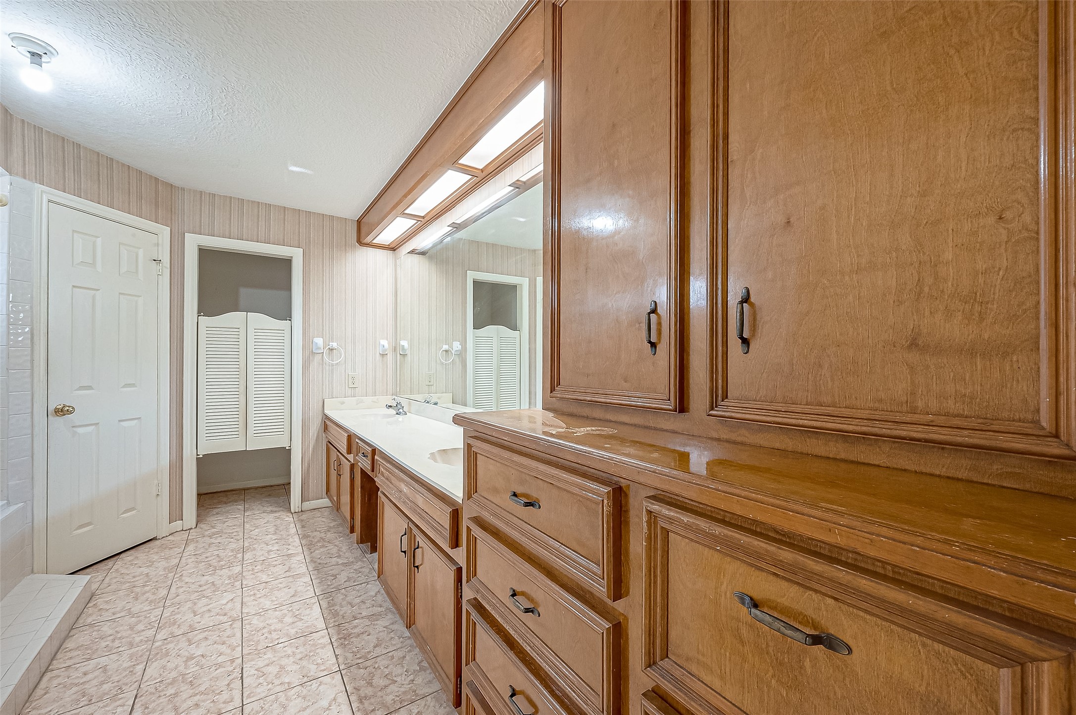 14818 La Rana Drive Houston, TX 77083 - Photo 33 of 50 a spacious bathroom with a double vanity sink and a mirror