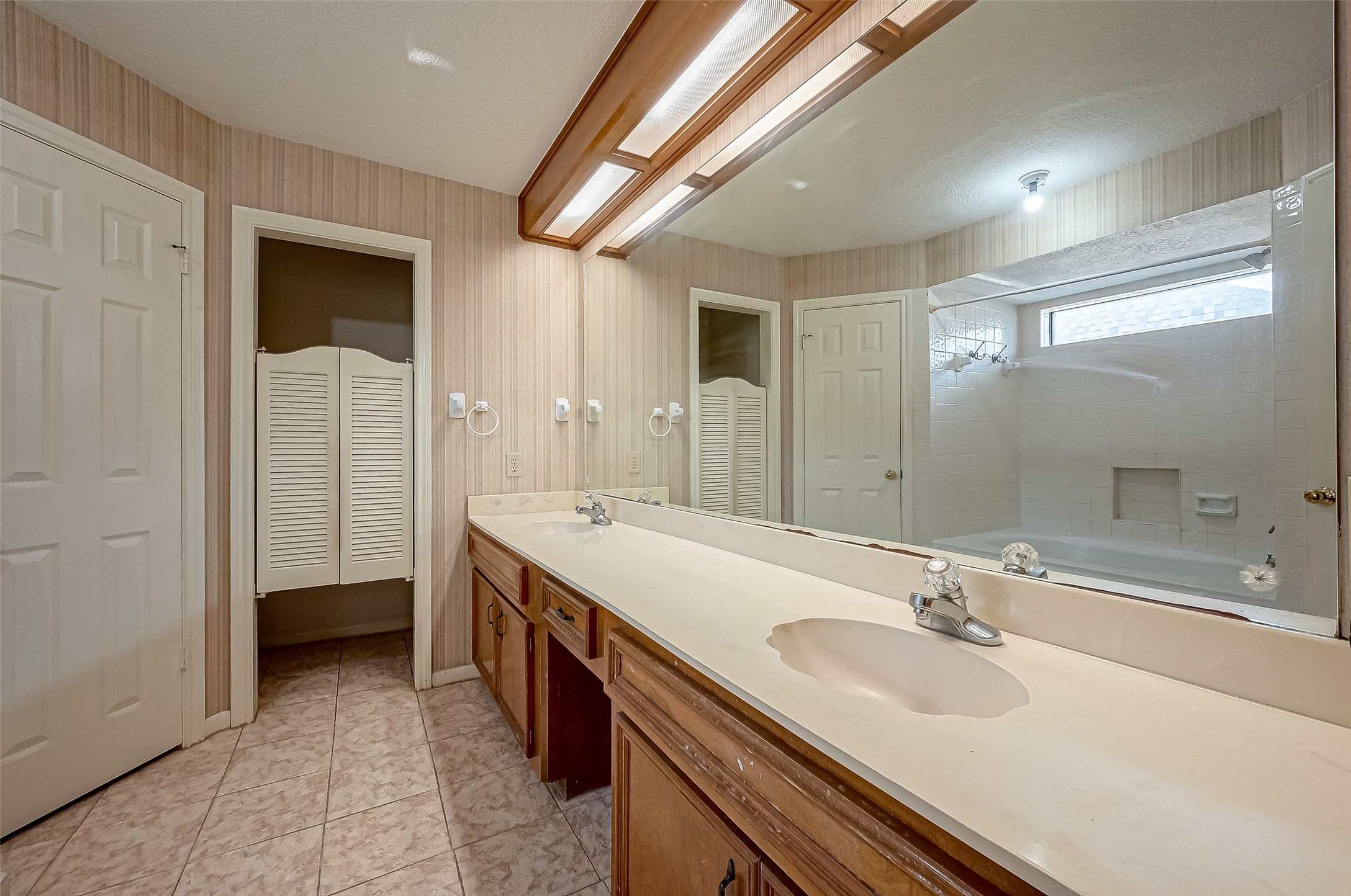14818 La Rana Drive Houston, TX 77083 - Photo 34 of 50 a spacious bathroom with a double vanity sink a and a mirror
