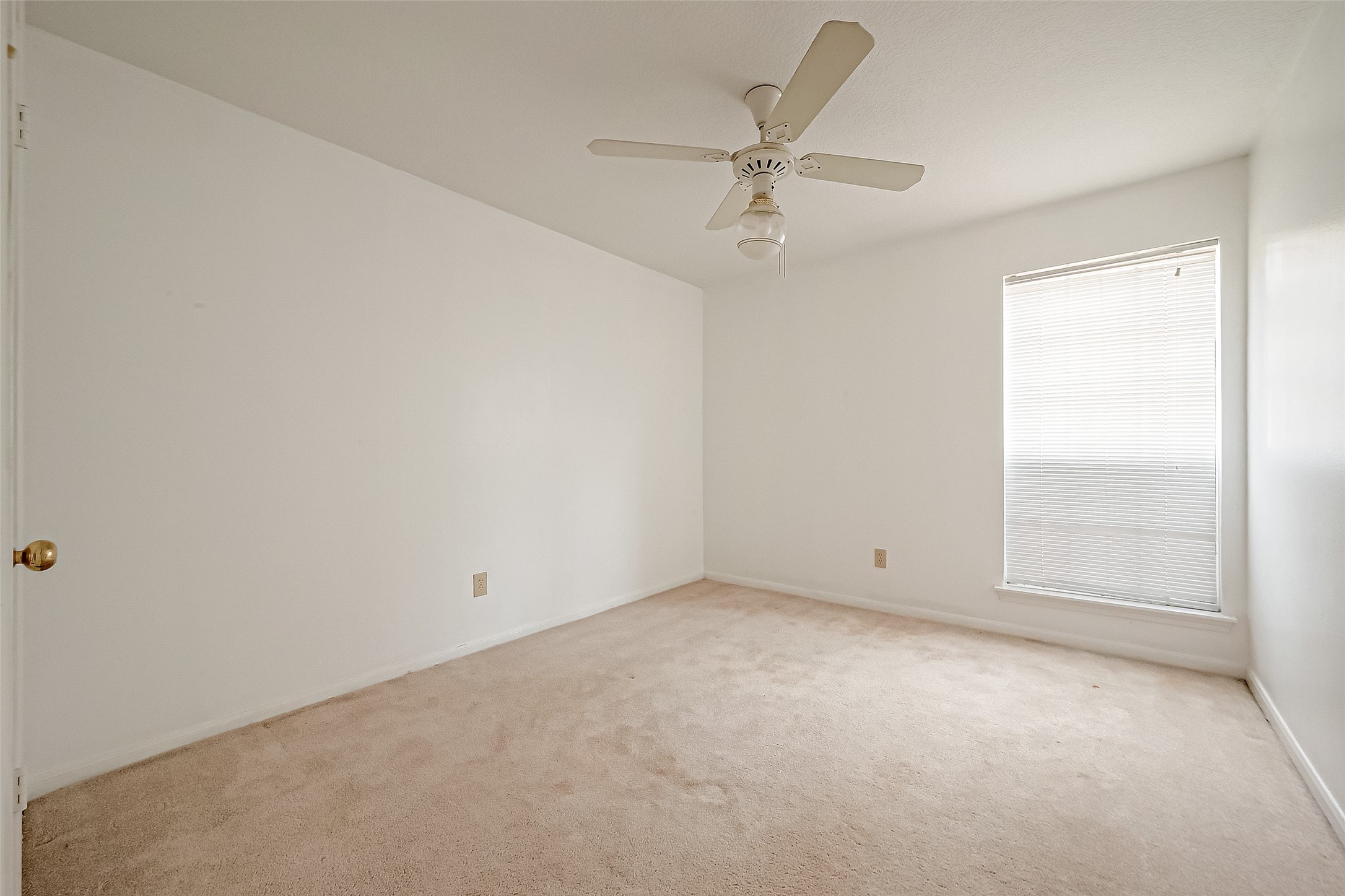 14818 La Rana Drive Houston, TX 77083 - Photo 42 of 50 an empty room with a window and a fan