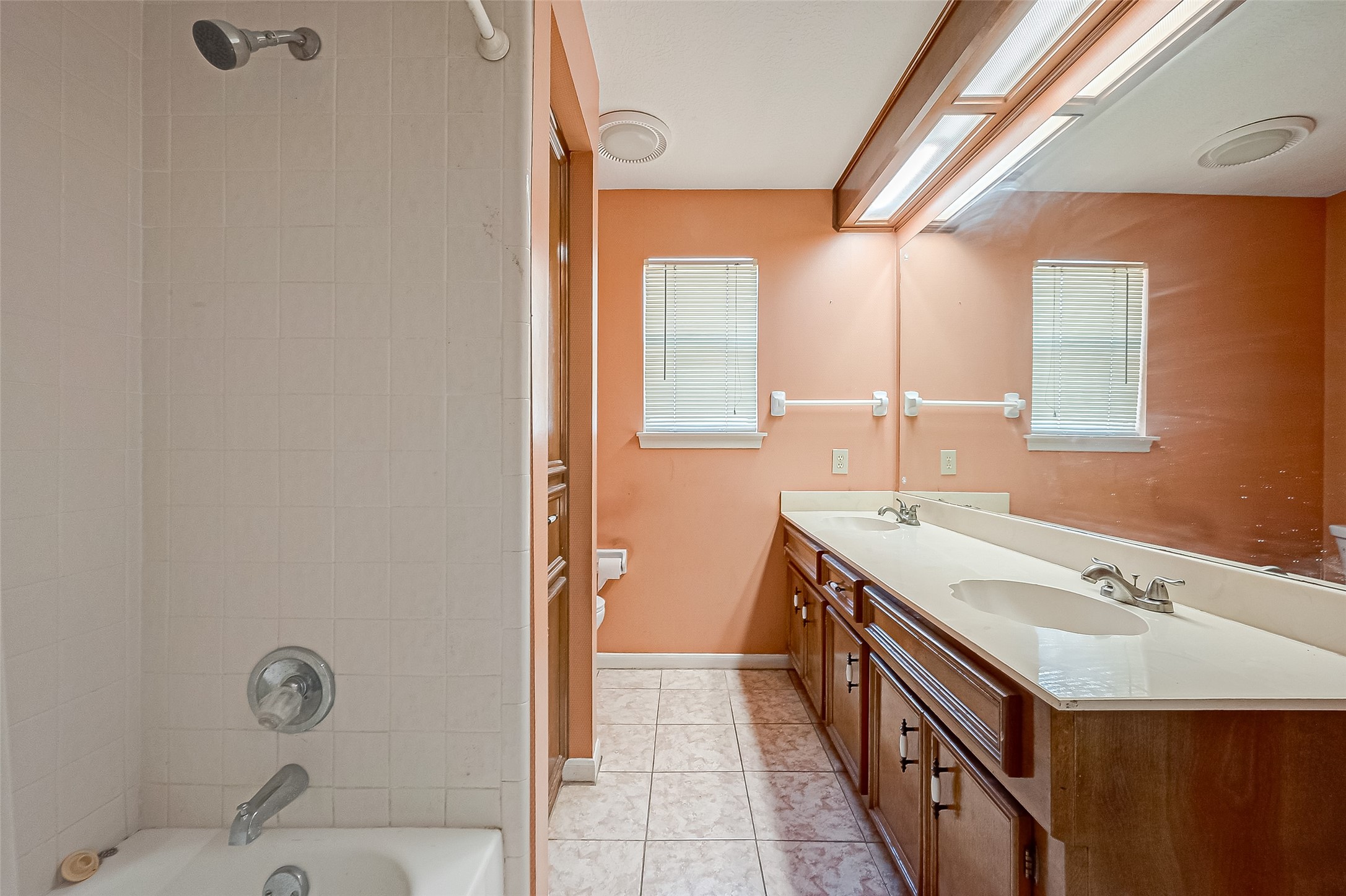 14818 La Rana Drive Houston, TX 77083 - Photo 45 of 50 a bathroom with a sink a mirror and a bathtub