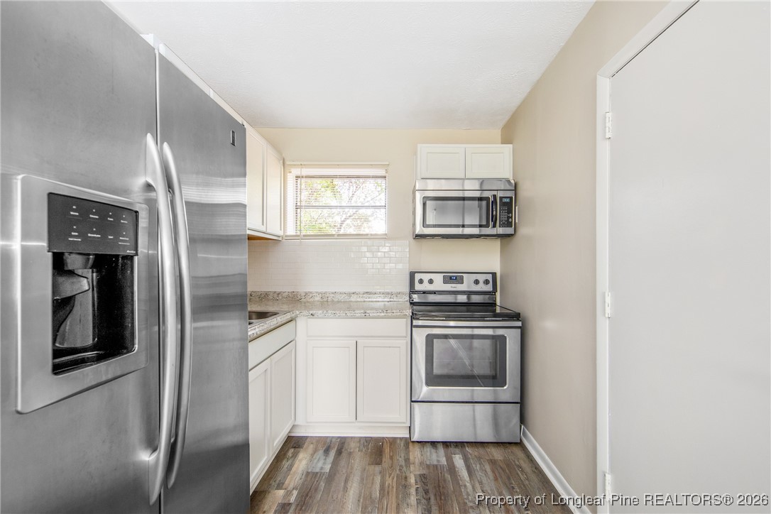 4305 Rosehill Road, Unit D Fayetteville, NC 28311 - Photo 3 of 10 a kitchen with stainless steel appliances granite countertop a stove and a refrigerator