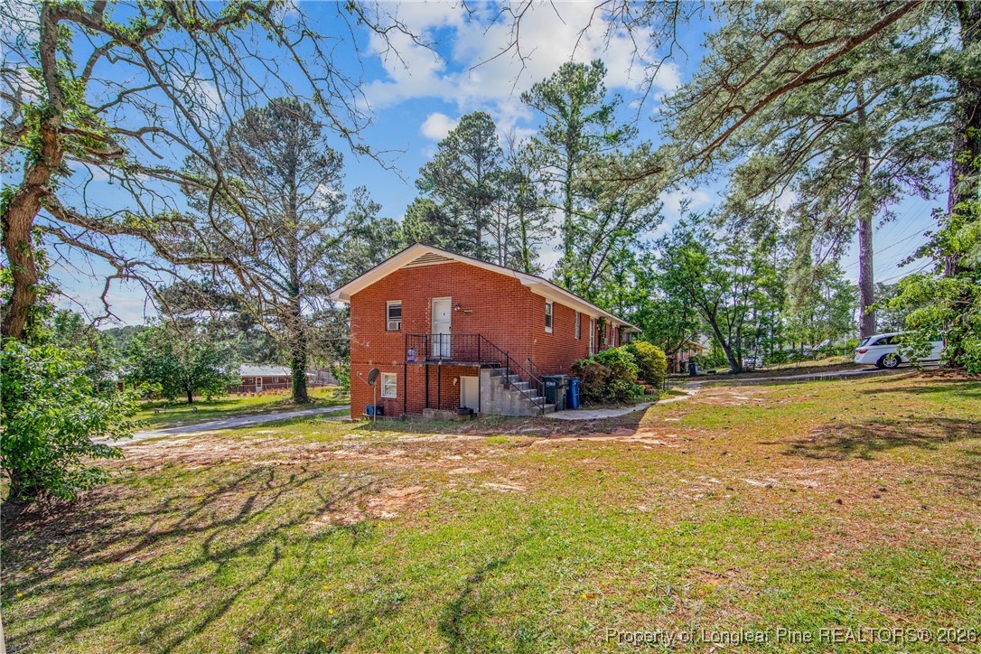 4305 Rosehill Road, Unit D Fayetteville, NC 28311 - Photo 6 of 10 a view of a house with a yard