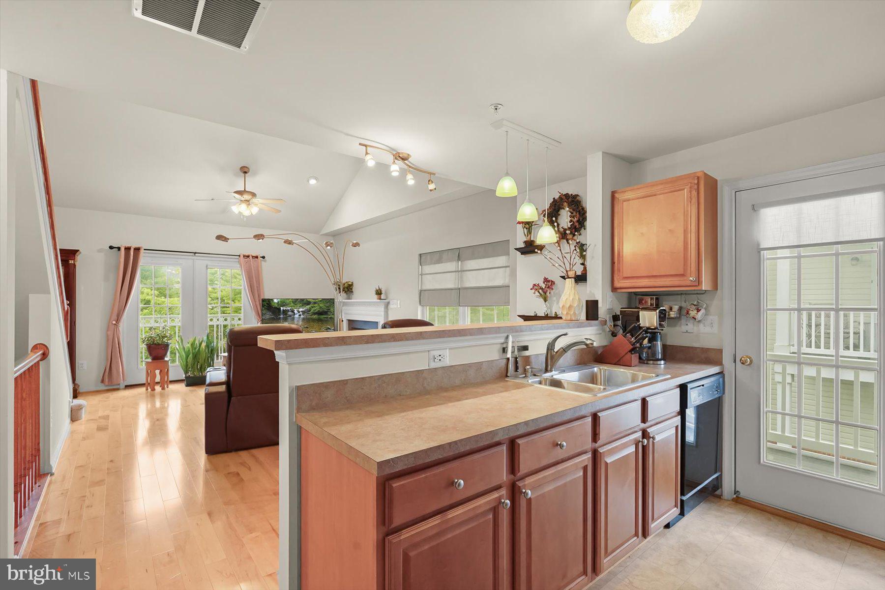 2044 Astilbe Way, Unit 2044 Odenton, MD 21113 - Photo 12 of 56 a kitchen with kitchen island granite countertop a sink stove and cabinets