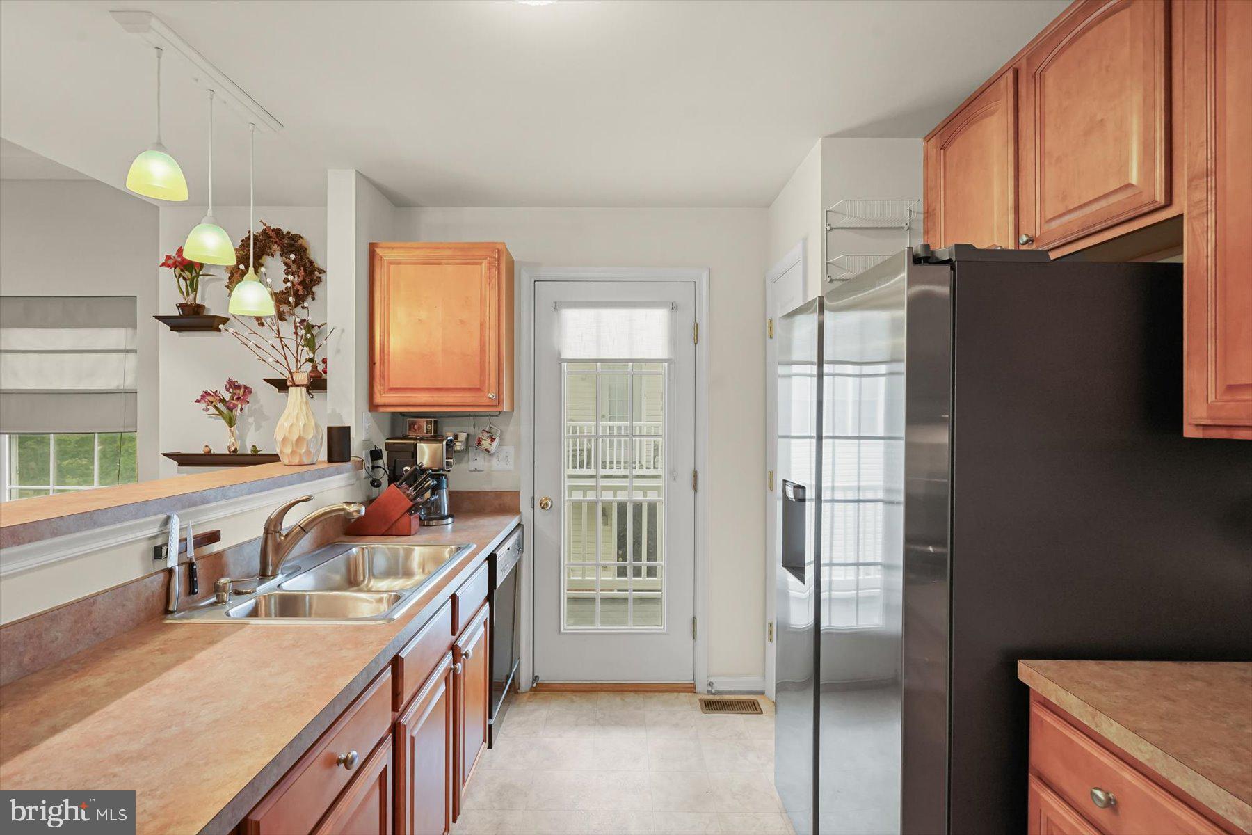 2044 Astilbe Way, Unit 2044 Odenton, MD 21113 - Photo 13 of 56 a kitchen with a sink stove and refrigerator