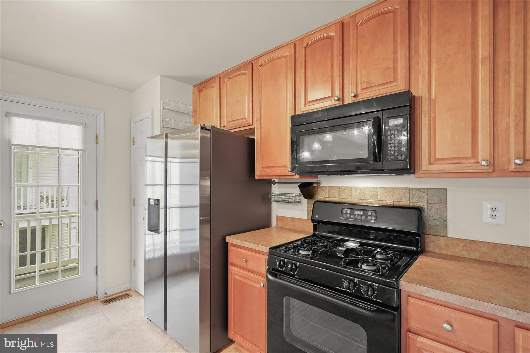 2044 Astilbe Way, Unit 2044 Odenton, MD 21113 - Photo 16 of 56 a kitchen with granite countertop cabinets and steel stainless steel appliances