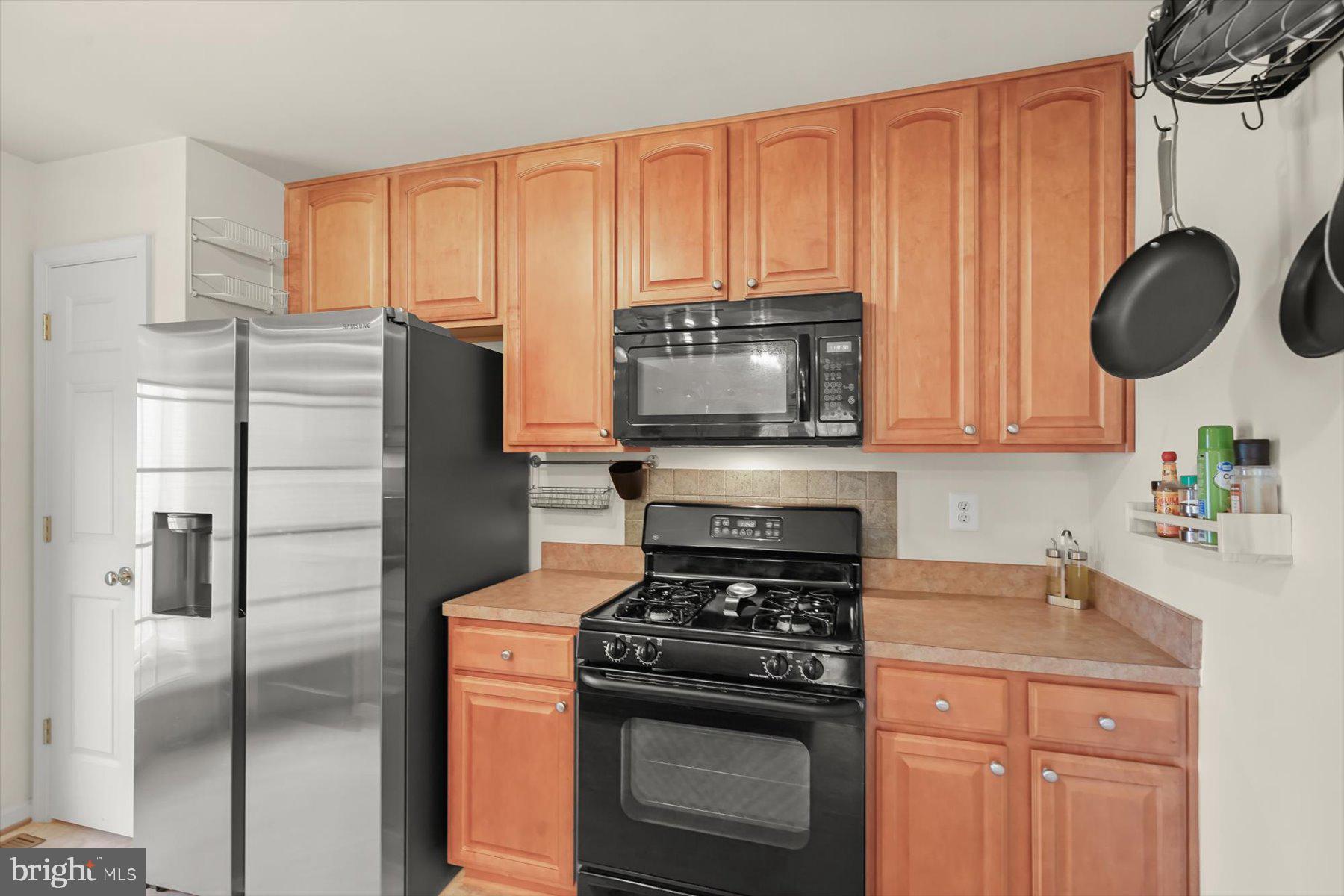 2044 Astilbe Way, Unit 2044 Odenton, MD 21113 - Photo 17 of 56 a kitchen with stainless steel appliances a stove a microwave and cabinets