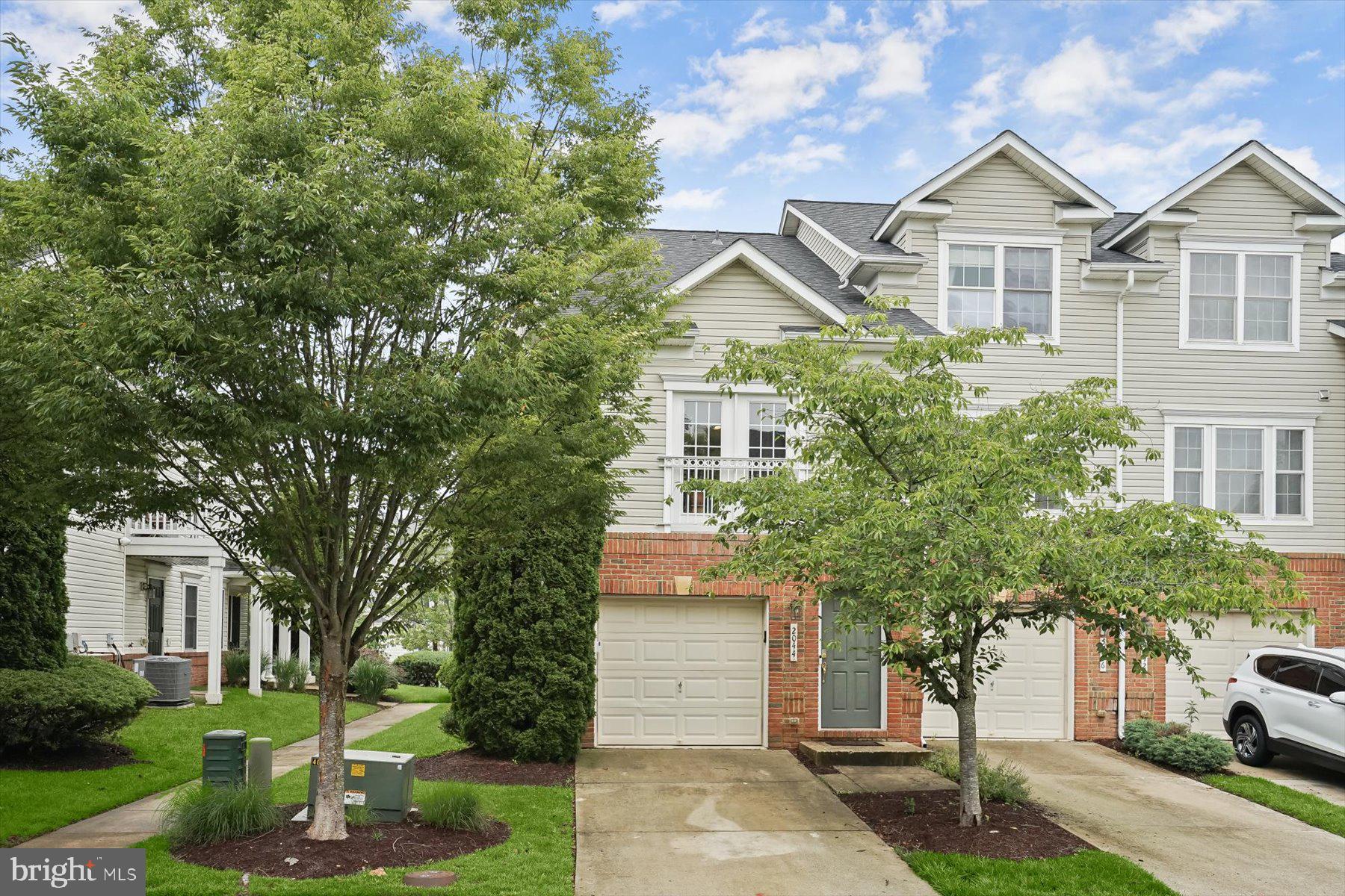 2044 Astilbe Way, Unit 2044 Odenton, MD 21113 - Photo 2 of 56 a front view of a house with a yard and tree s
