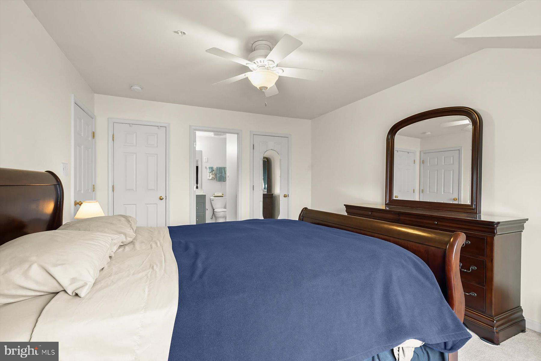 2044 Astilbe Way, Unit 2044 Odenton, MD 21113 - Photo 34 of 56 a bedroom with a bed and a chandelier