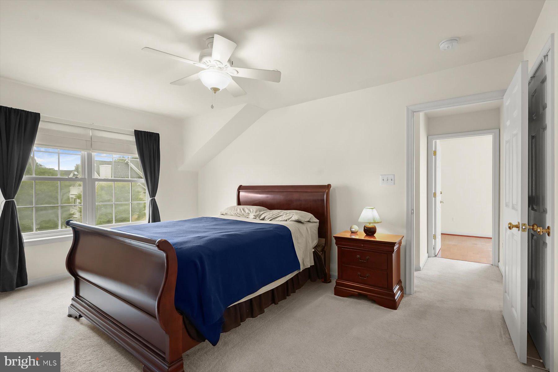 2044 Astilbe Way, Unit 2044 Odenton, MD 21113 - Photo 35 of 56 a spacious bedroom with a bed and large window