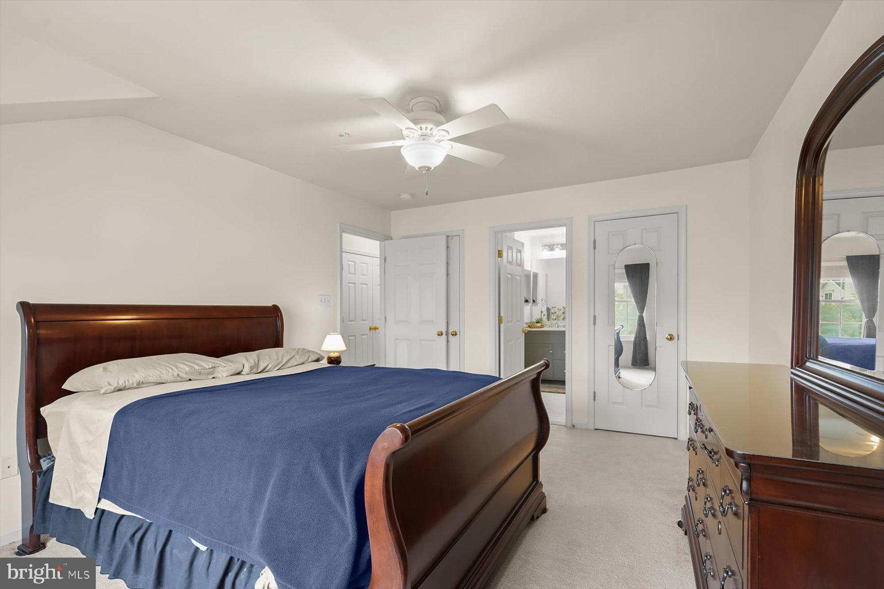 2044 Astilbe Way, Unit 2044 Odenton, MD 21113 - Photo 36 of 56 a bedroom with a bed and a chandelier