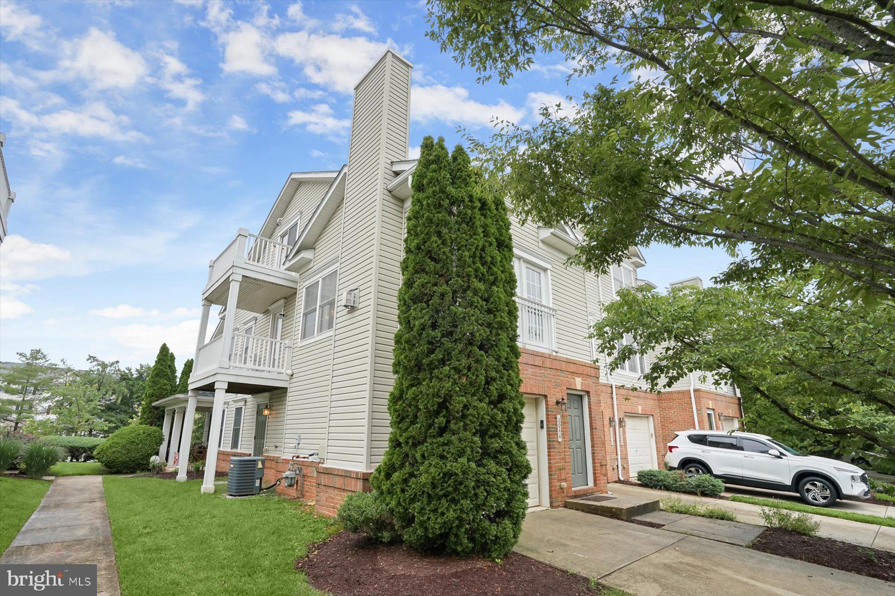 2044 Astilbe Way, Unit 2044 Odenton, MD 21113 - Photo 4 of 56 a white house with a tree in the background