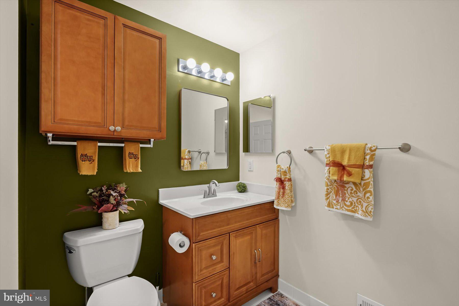2044 Astilbe Way, Unit 2044 Odenton, MD 21113 - Photo 49 of 56 a bathroom with a toilet sink and mirror