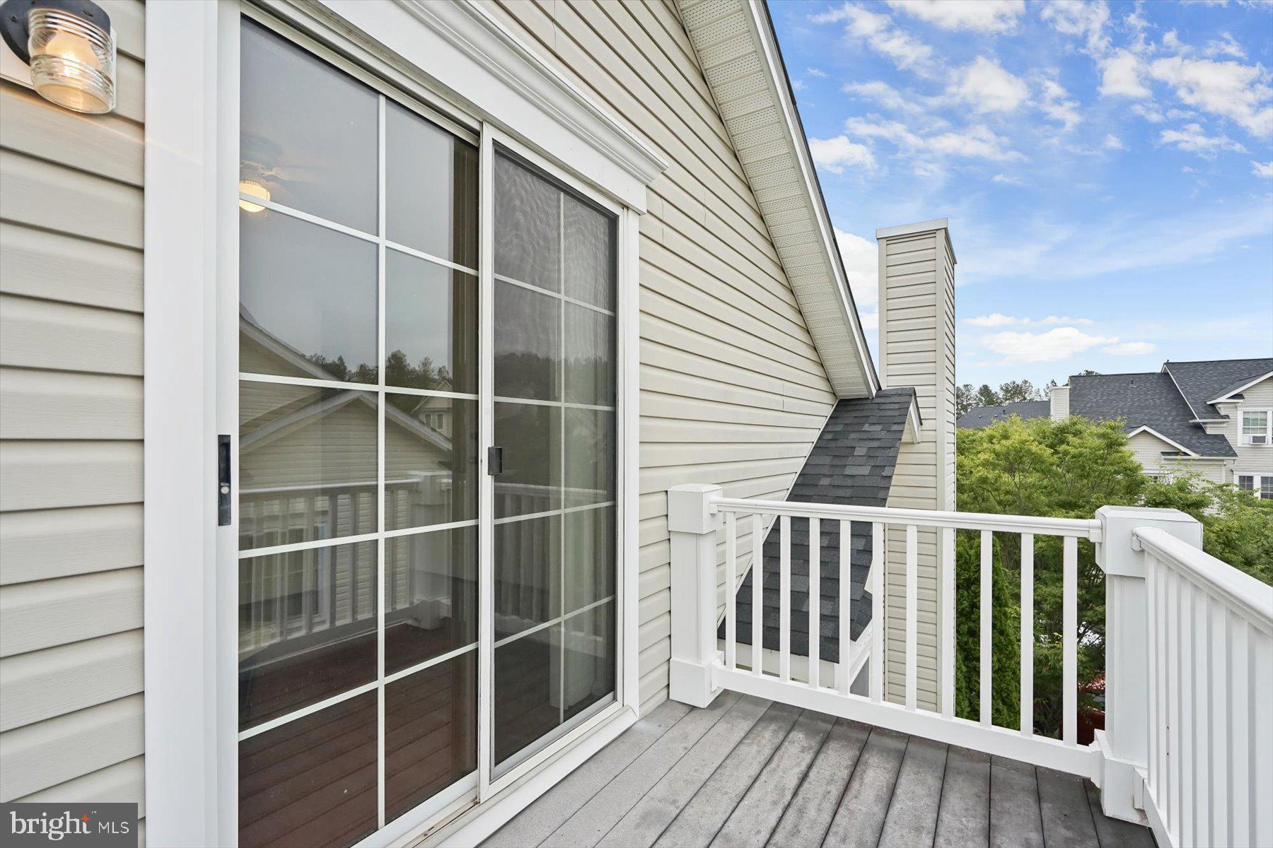 2044 Astilbe Way, Unit 2044 Odenton, MD 21113 - Photo 50 of 56 a view of a balcony with wooden floor