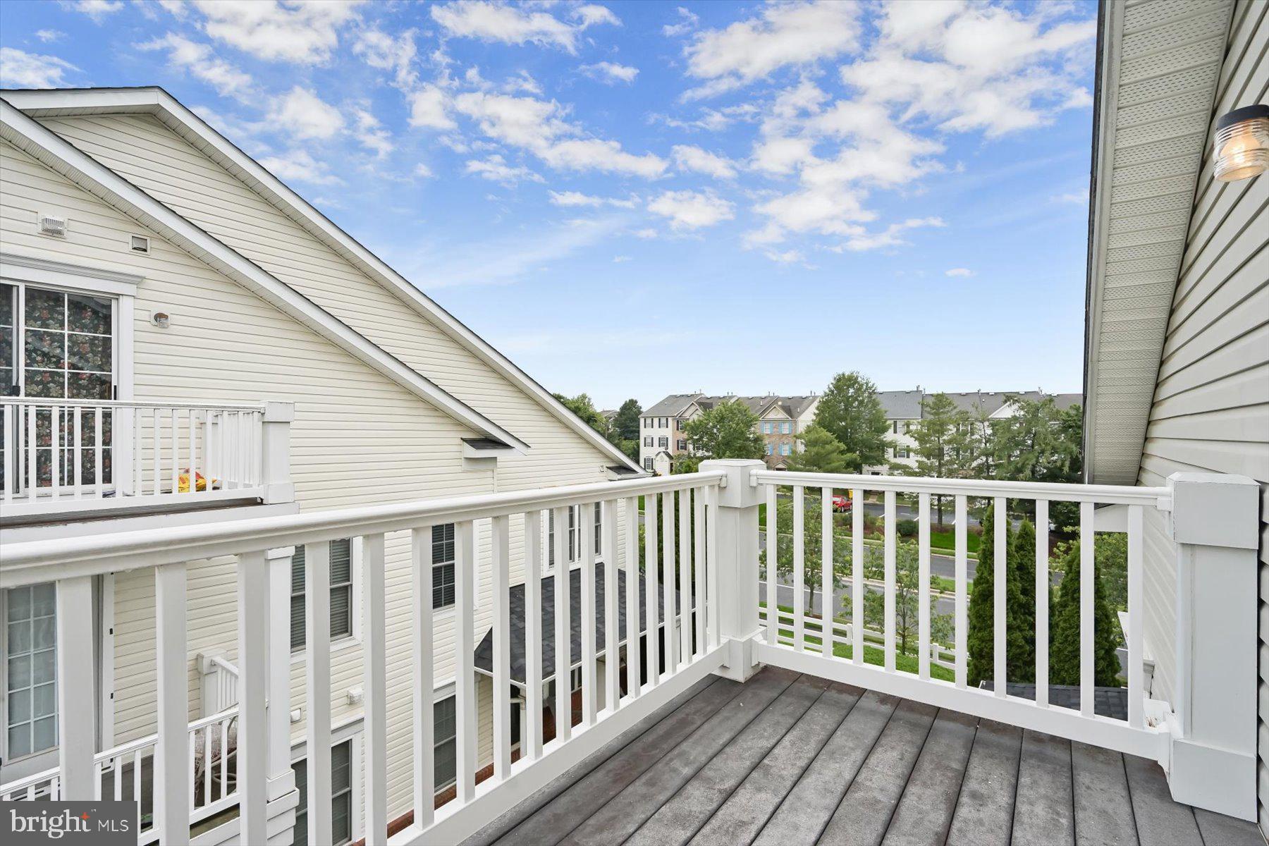 2044 Astilbe Way, Unit 2044 Odenton, MD 21113 - Photo 52 of 56 a balcony with wooden floor and fence