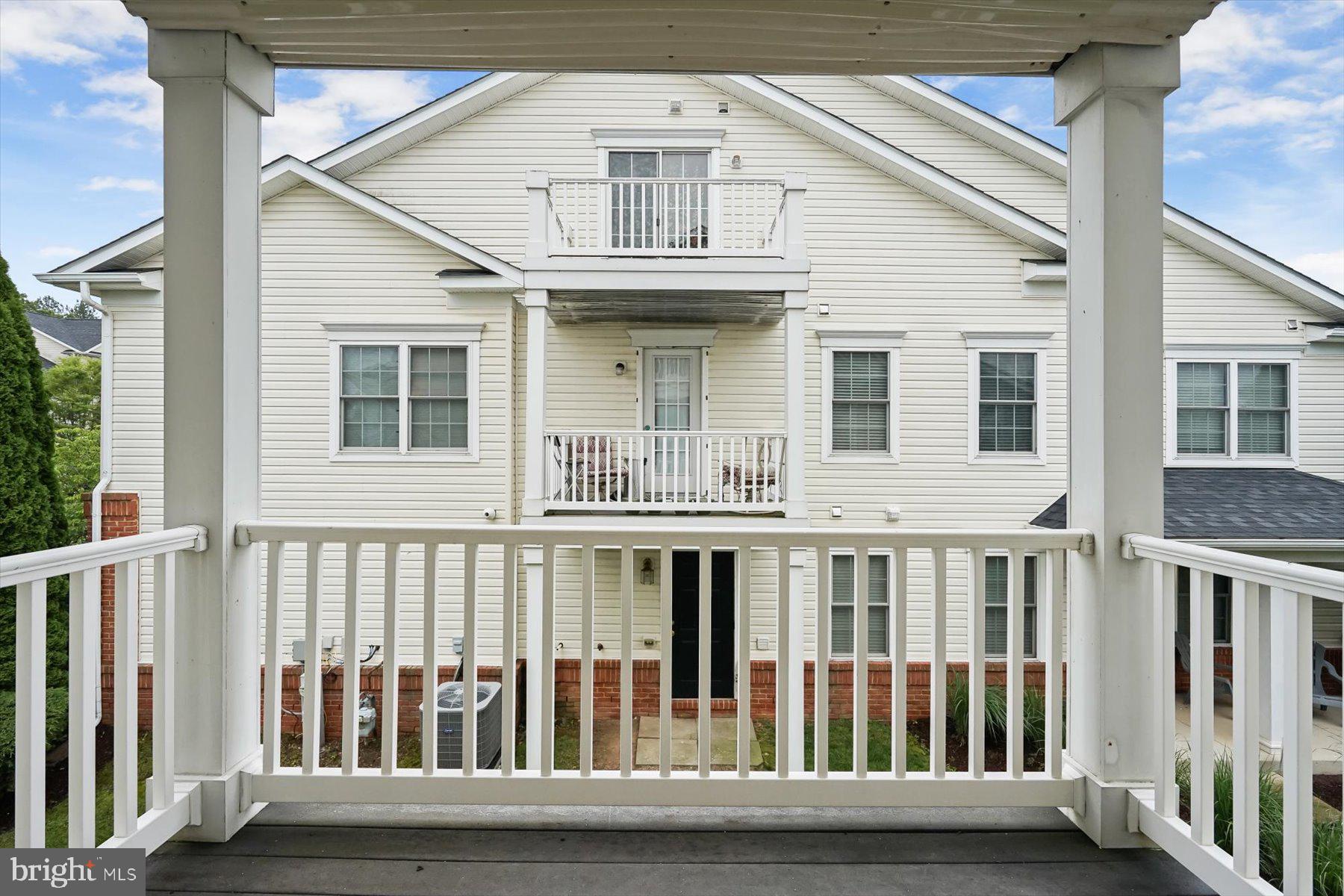 2044 Astilbe Way, Unit 2044 Odenton, MD 21113 - Photo 53 of 56 a view of a white house with a deck
