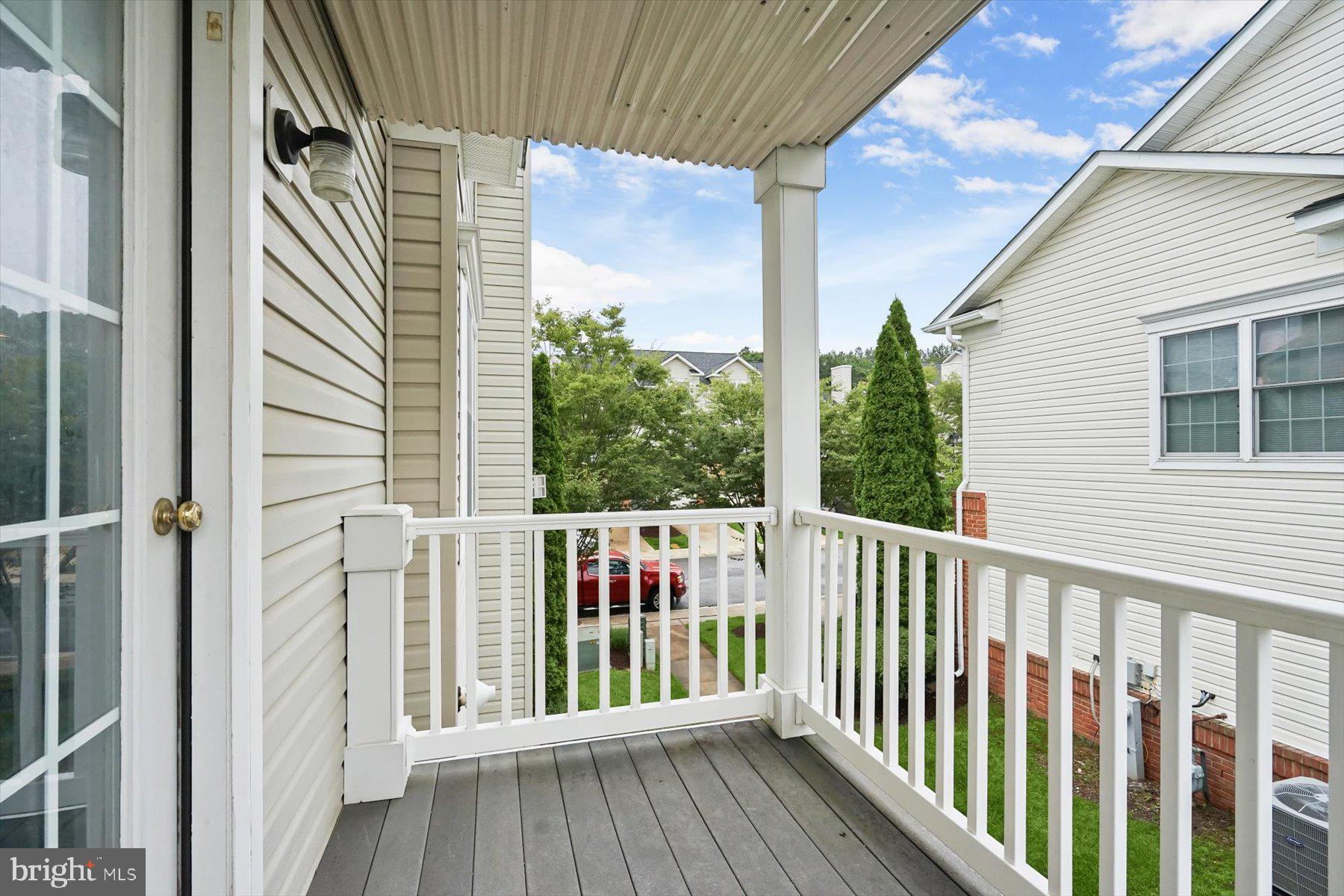 2044 Astilbe Way, Unit 2044 Odenton, MD 21113 - Photo 55 of 56 a view of a balcony with wooden floor