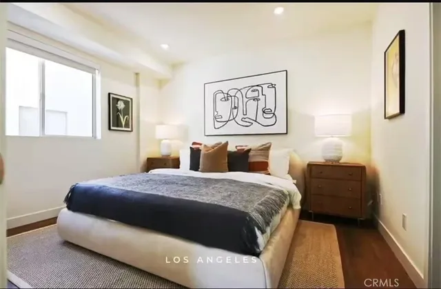 a bedroom with a bed and a painting on the wall