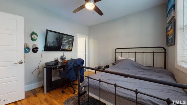 a bed sitting in a bedroom next to a window