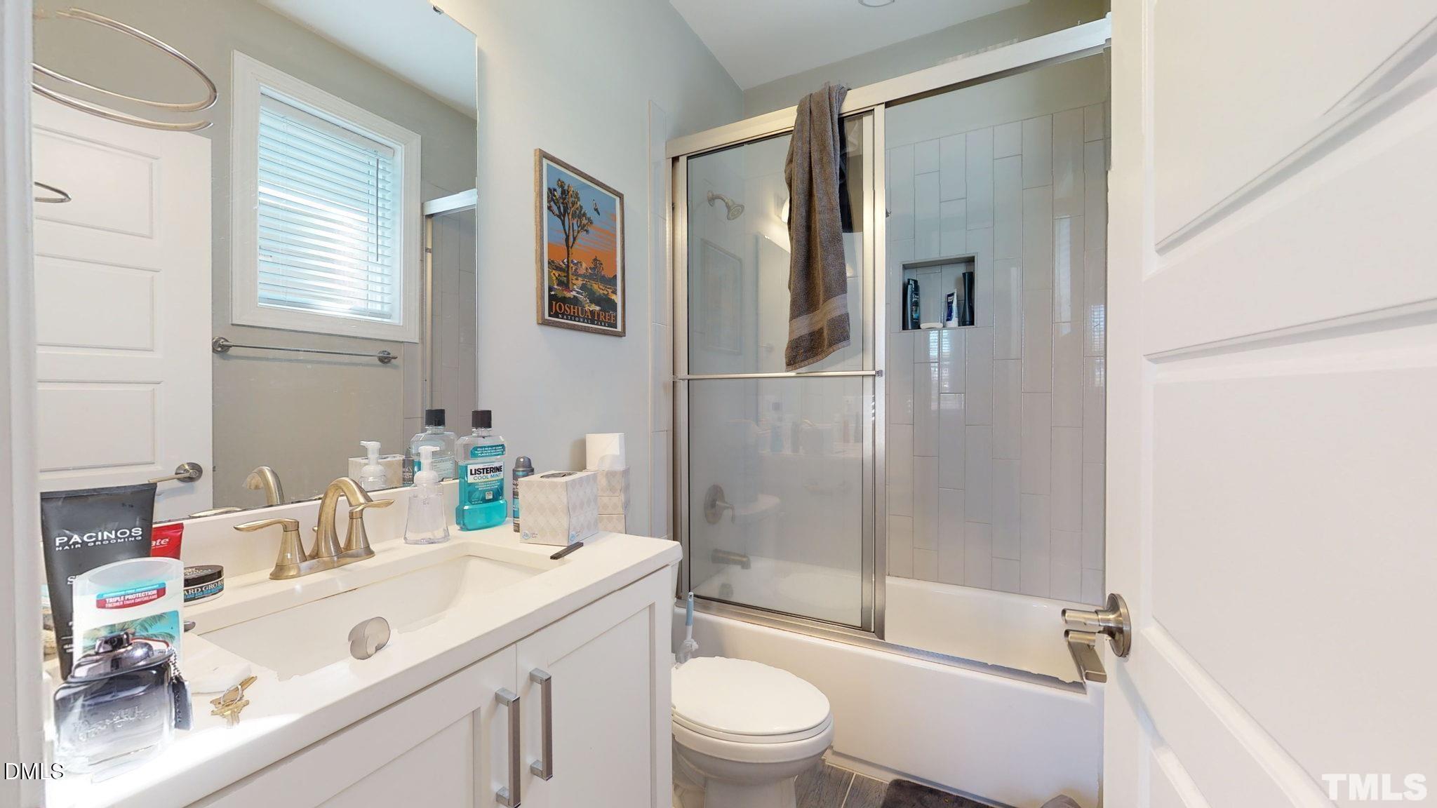 5012 Western Boulevard Raleigh, NC 27606 - Photo 14 of 24 a bathroom with a sink a toilet and shower