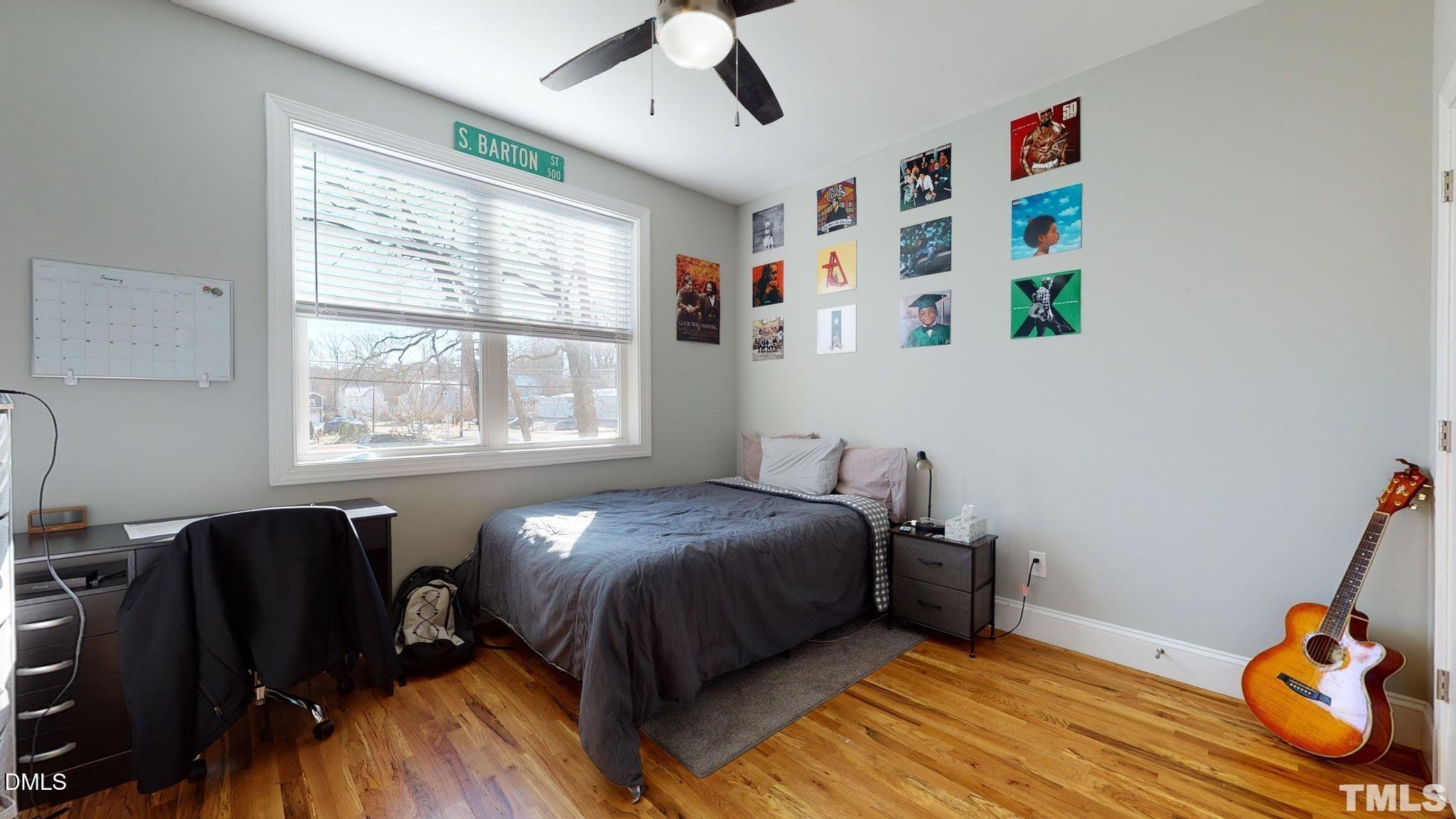 5012 Western Boulevard Raleigh, NC 27606 - Photo 16 of 24 a bedroom with a bed and wooden floor