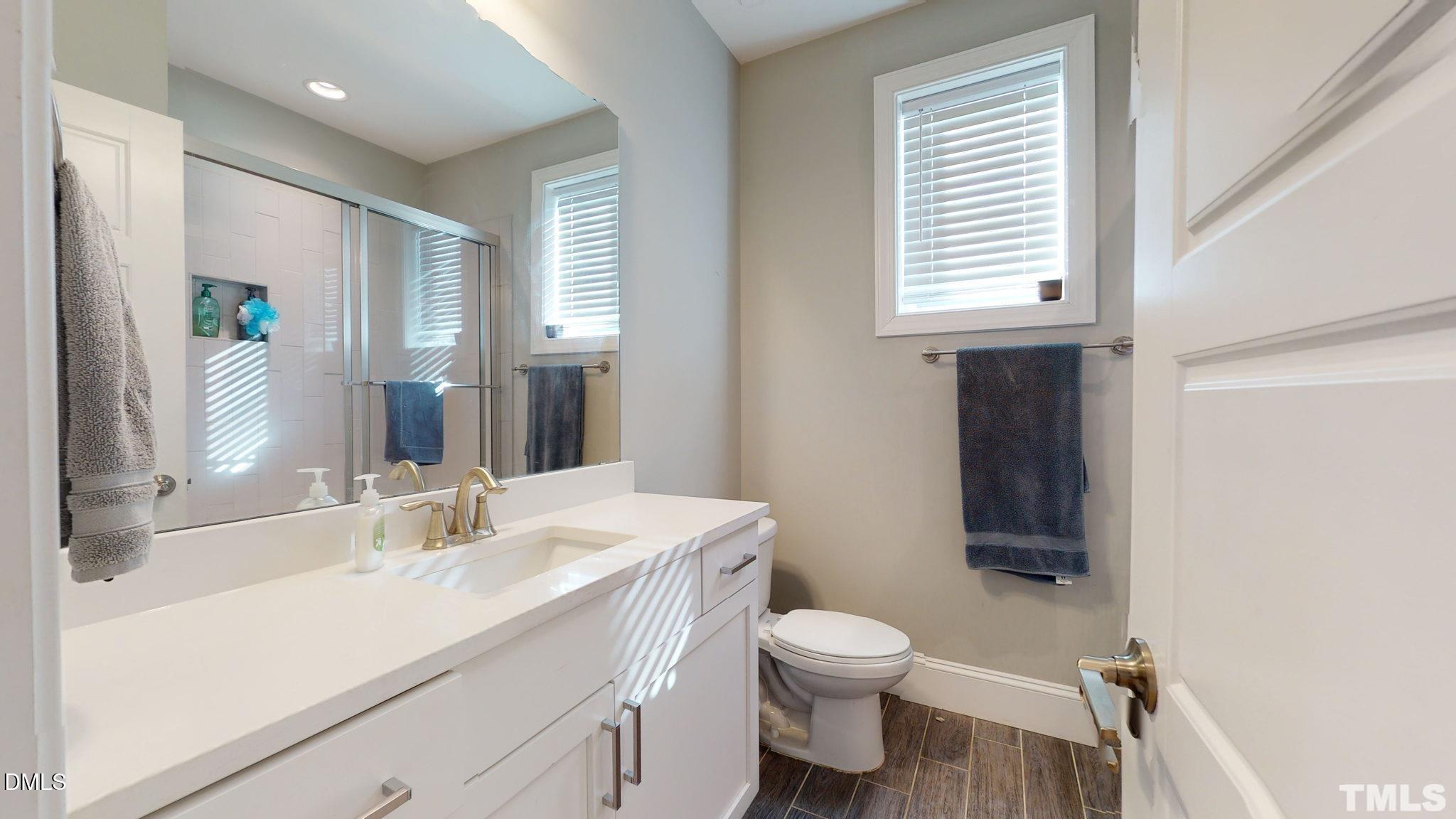 5012 Western Boulevard Raleigh, NC 27606 - Photo 18 of 24 a bathroom with a sink toilet vanity and shower