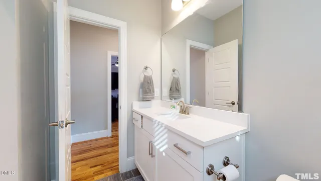 a bathroom with a sink toilet vanity and shower