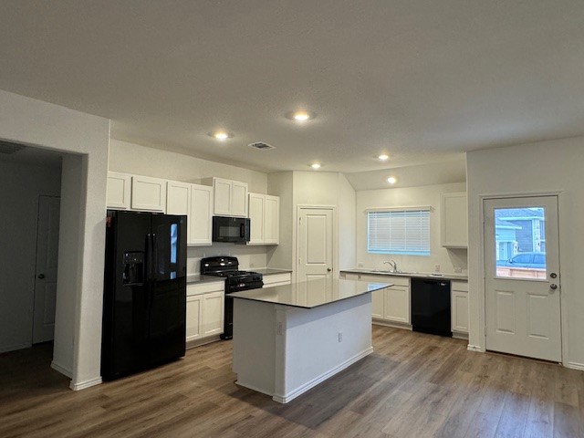 222 Carmello Kyle, TX 78640 - Photo 10 of 30 a kitchen with stainless steel appliances kitchen island granite countertop a refrigerator and a stove top oven