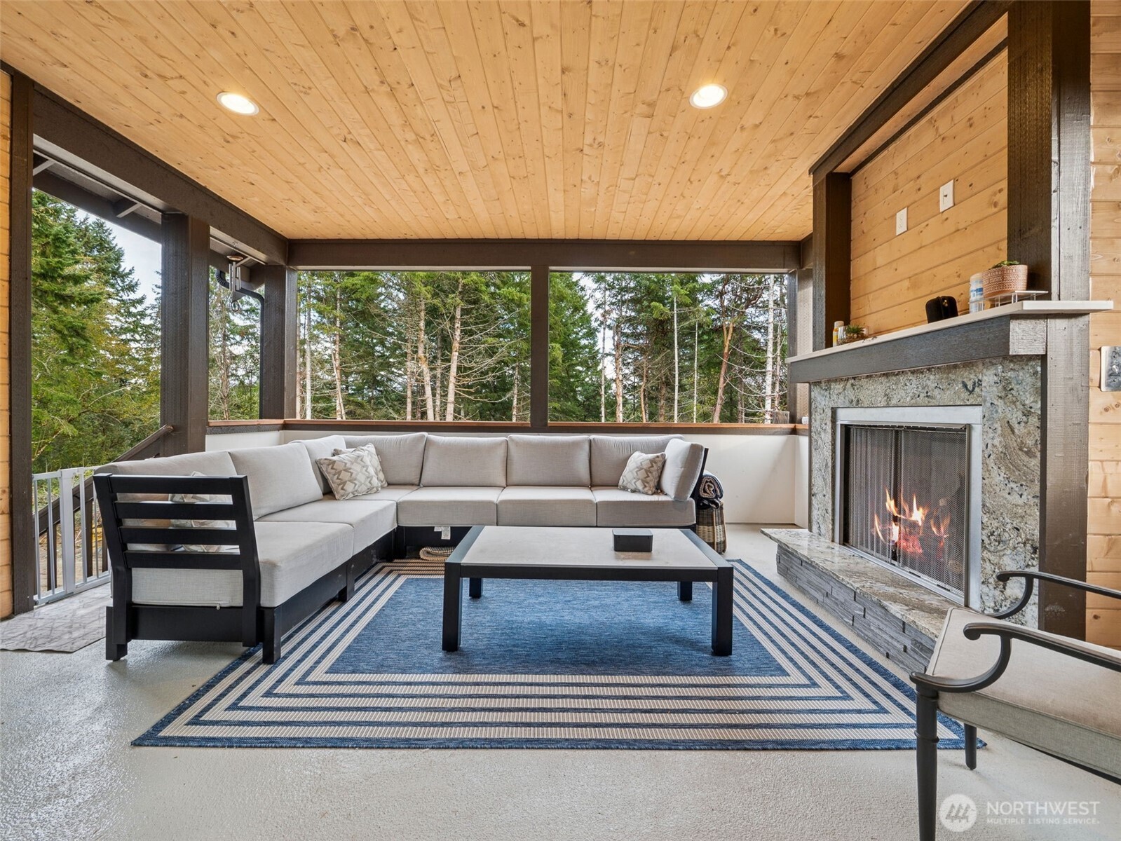 917 Tiedman Road Northwest Lakebay, WA 98349 - Photo 15 of 39 a living room with furniture a large window and a fireplace