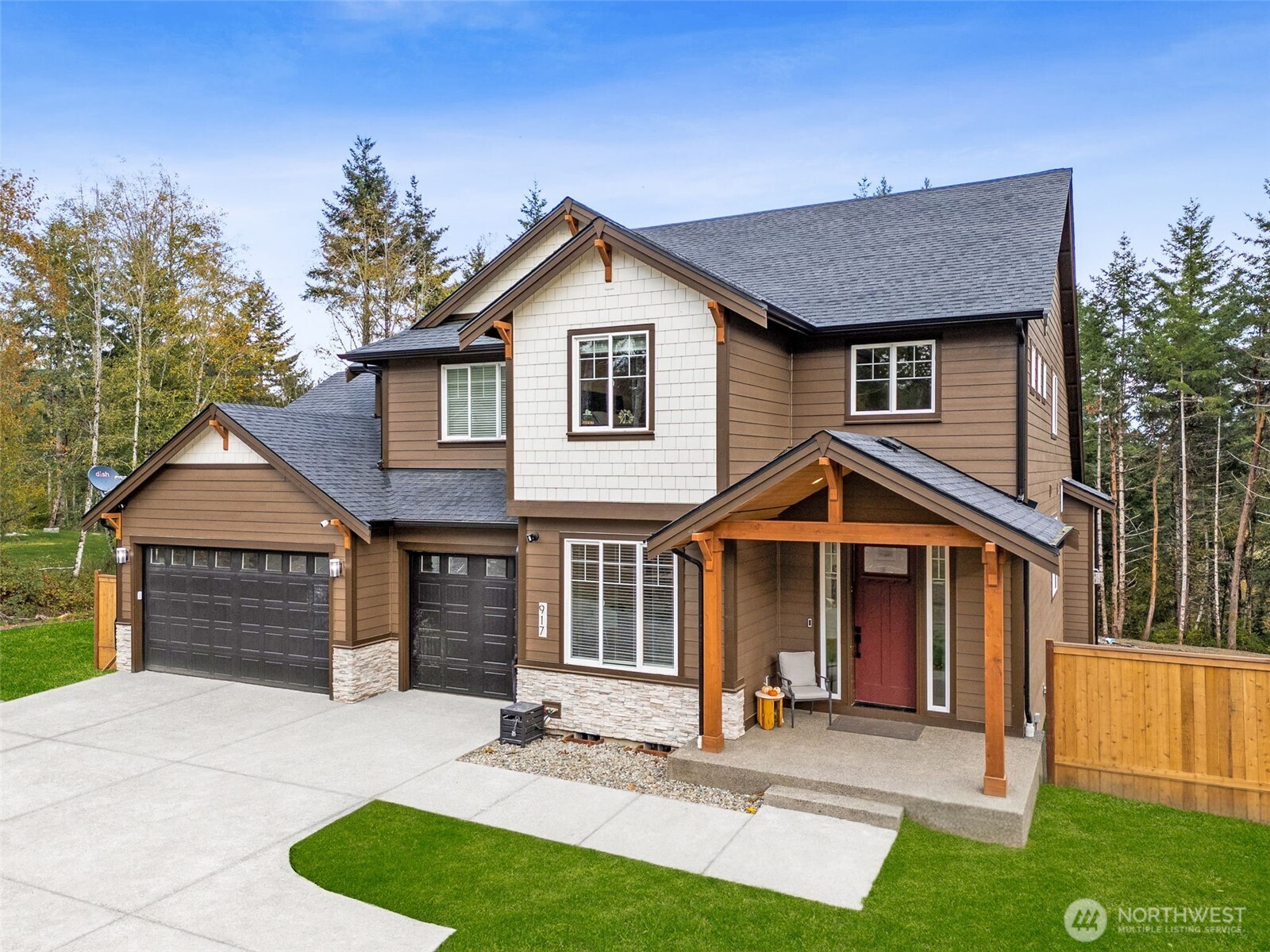 917 Tiedman Road Northwest Lakebay, WA 98349 - Photo 2 of 39 a front view of a house with a yard and garage