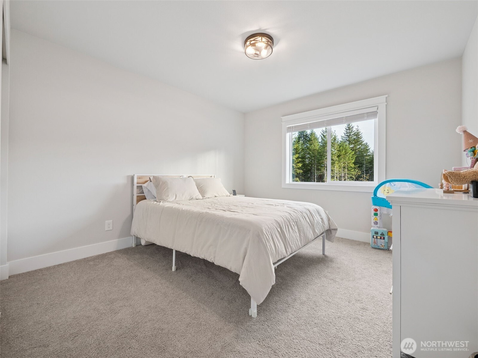 917 Tiedman Road Northwest Lakebay, WA 98349 - Photo 25 of 39 a spacious bedroom with a bed and a window
