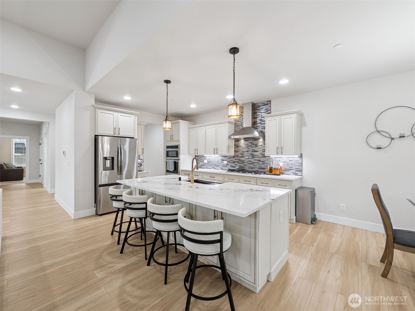 917 Tiedman Road Northwest Lakebay, WA 98349 - Photo 9 of 39 a kitchen with stainless steel appliances a dining table chairs stove refrigerator and cabinets