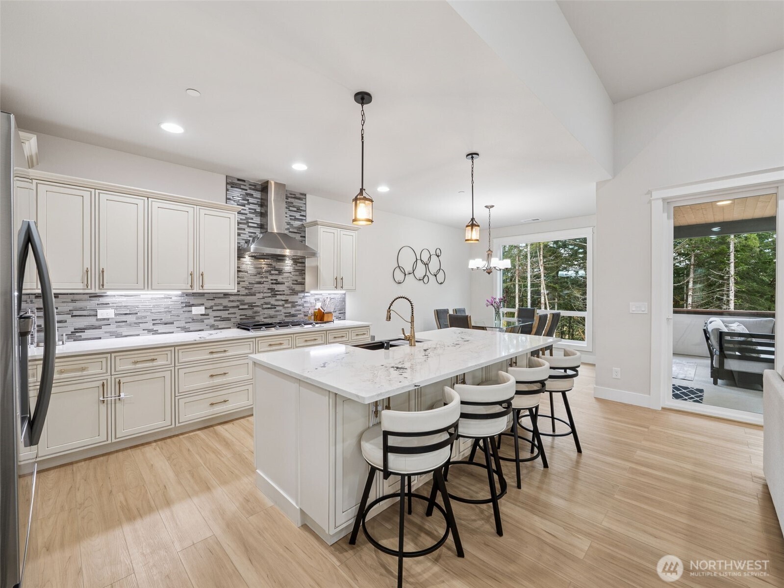 917 Tiedman Road Northwest Lakebay, WA 98349 - Photo 10 of 39 a kitchen with a dining table chairs sink and cabinets