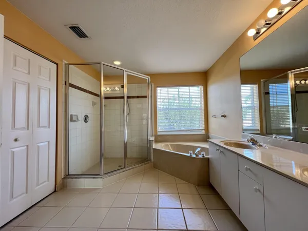 a spacious bathroom with a tub shower and sink