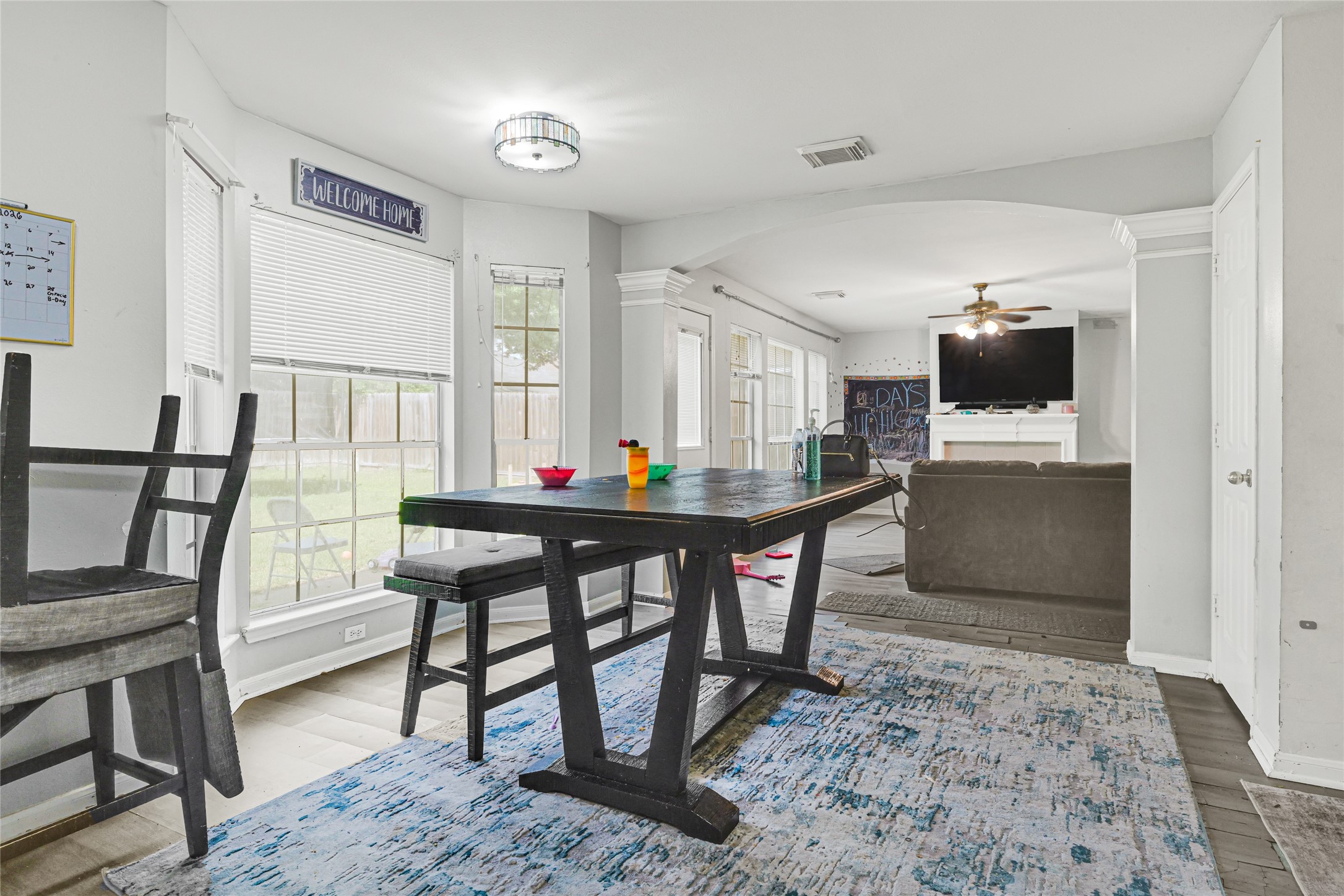 6419 Slate Stone Street Houston, TX 77084 - Photo 11 of 49 Bright and inviting dining area with large windows and an open layout leading to a cozy living room. Perfect for entertaining and family gatherings.