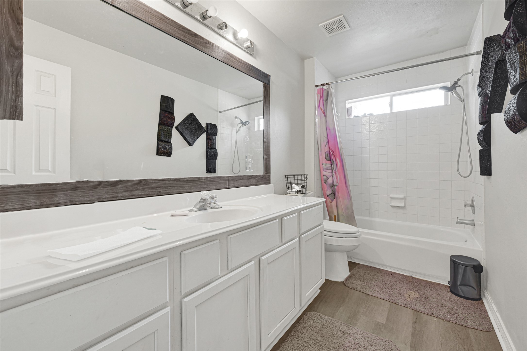6419 Slate Stone Street Houston, TX 77084 - Photo 28 of 49 This bathroom features a double-sink vanity with ample counter space, a large mirror with modern lighting, and a shower-tub combo. The decor is minimal, with neutral tones and contemporary accents.