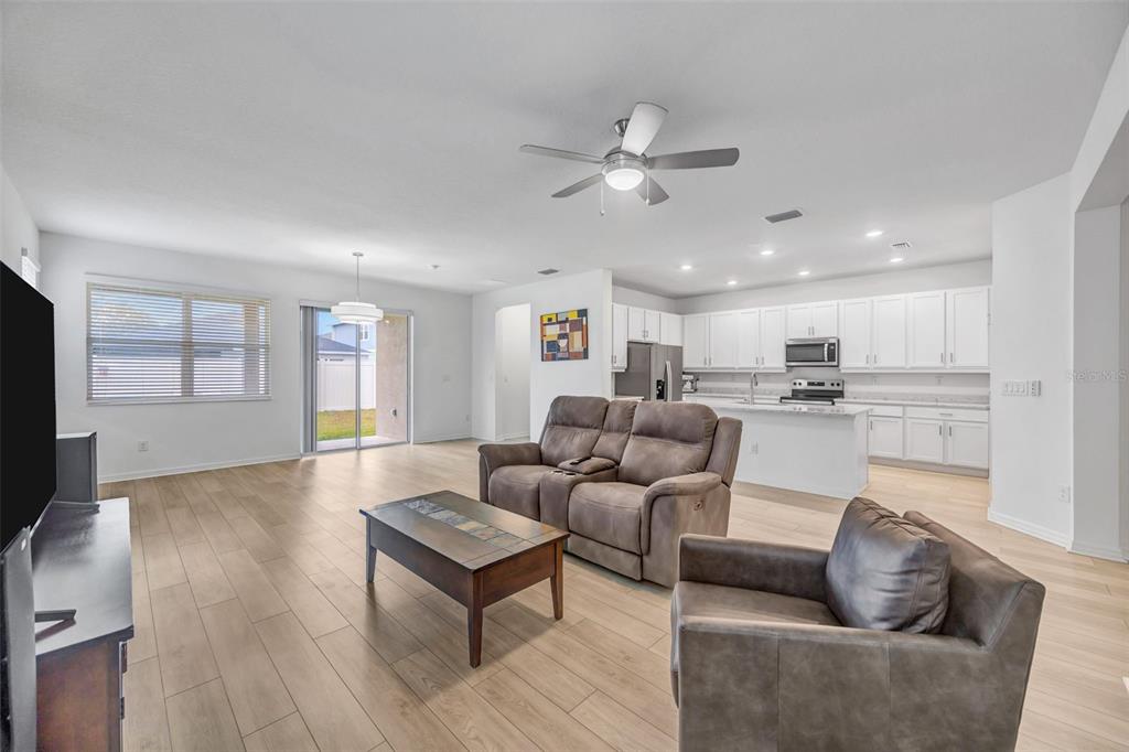 7882 Lennox Loop Wesley Chapel, FL 33544 - Photo 12 of 58 a living room with furniture and kitchen view