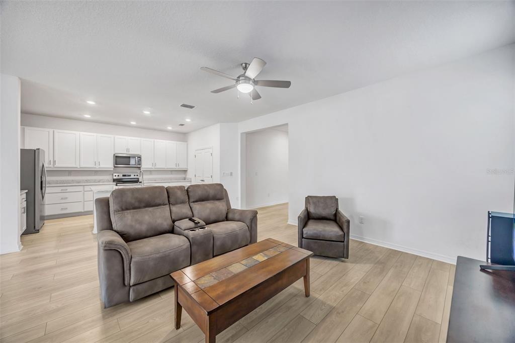 7882 Lennox Loop Wesley Chapel, FL 33544 - Photo 13 of 58 a living room with furniture and kitchen view