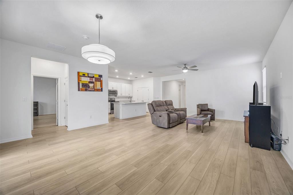 7882 Lennox Loop Wesley Chapel, FL 33544 - Photo 17 of 58 a view of a room with furniture and wooden floor
