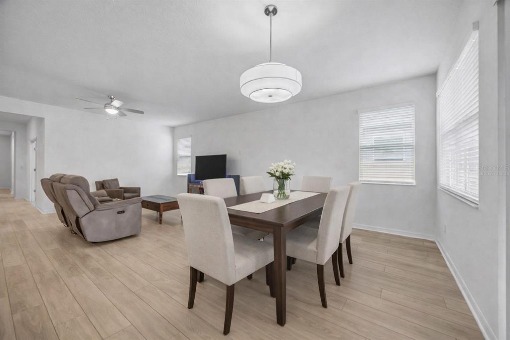 7882 Lennox Loop Wesley Chapel, FL 33544 - Photo 18 of 58 a view of a dining room with furniture window and wooden floor